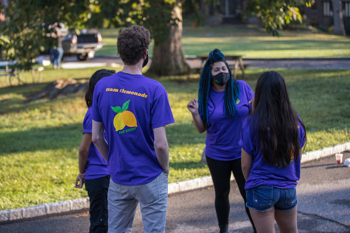 学生们围成一圈，穿着写着柠檬水队的衬衫