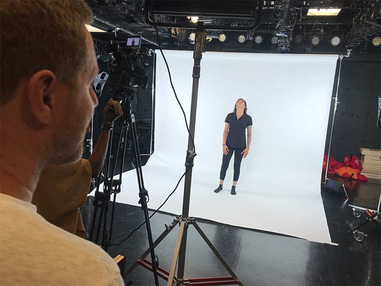 Filmmaking student standing on backdrop